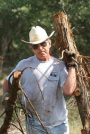 President Bush clears non-native cedar from the oaks at his ranch in Crawford, Texas, Aug. 9, 2002. (AP Photo/The White House, Eric Draper/File)